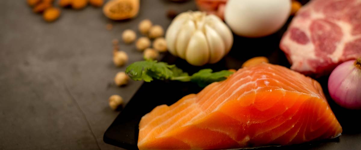 bilde av laks, kjøtt, nøtter og hvitløk. 
